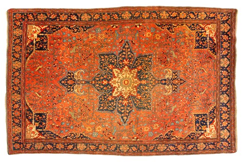 Lot 326 - An old Tabriz rug with a central star motif...