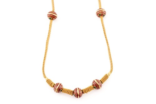 Lot 314 - A yellow metal and enamel necklace; the beaded...