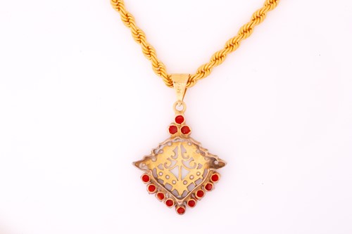 Lot 233 - A precious coral and seed pearl pendant on a...