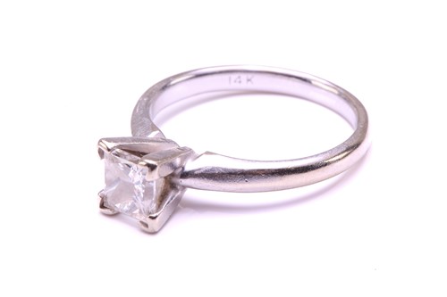 Lot 71 - A single-stone diamond ring. The princess cut...