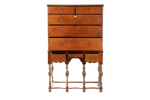 Lot 249 - An 18th century oak chest on later stand, the...