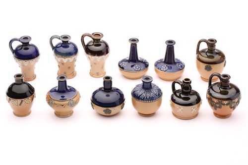 Lot 89 - Twelve Doulton stoneware miniature vases and...