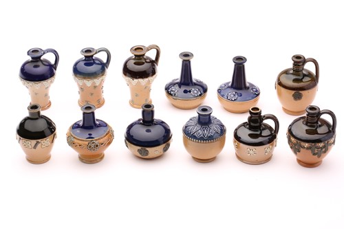 Lot 89 - Twelve Doulton stoneware miniature vases and...