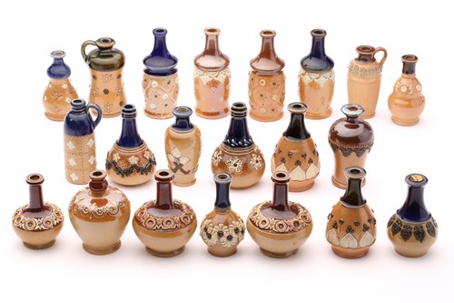 Lot 90 - Twenty one Doulton stoneware miniature vases...