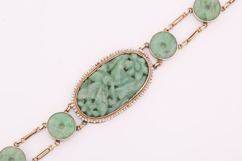 Lot 20 - A carved jade and pearl bracelet, featuring an...
