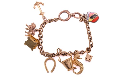 Lot 153 - A 9ct gold charm bracelet, consisting of a...
