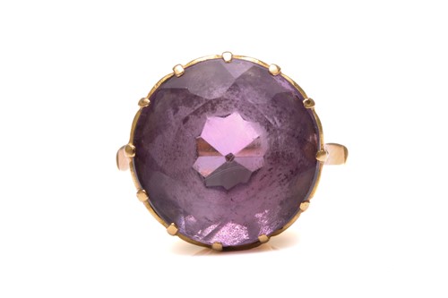 Lot 356 - An amethyst dress ring, comprising a round...