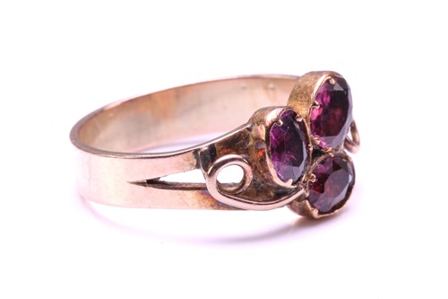Lot 110 - A Ruby and Garnet floral ring, formed from two...