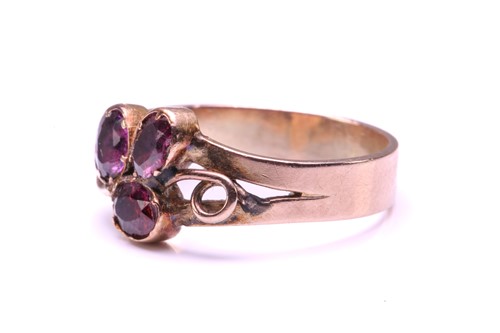 Lot 110 - A Ruby and Garnet floral ring, formed from two...