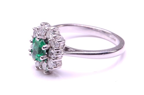 Lot 11 - An emerald and diamond entourage ring in 18ct...
