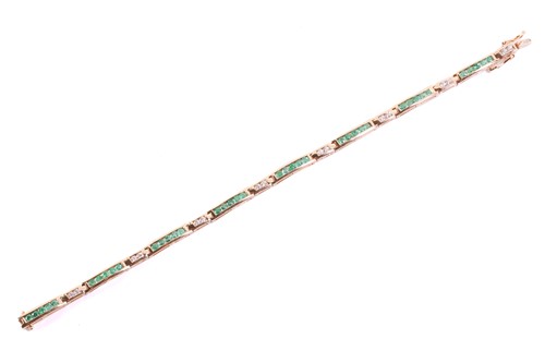 Lot 328 - An emerald and diamond line bracelet,...