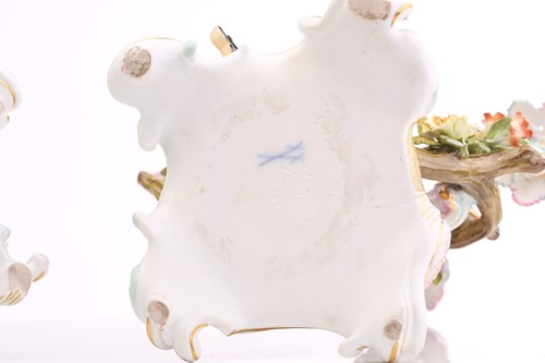 Lot 430 - A pair of Meissen three branch candelabra,...