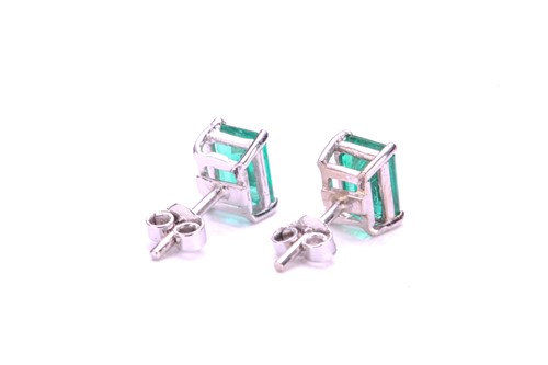 Lot 54 - A pair of emerald stud earrings, each...