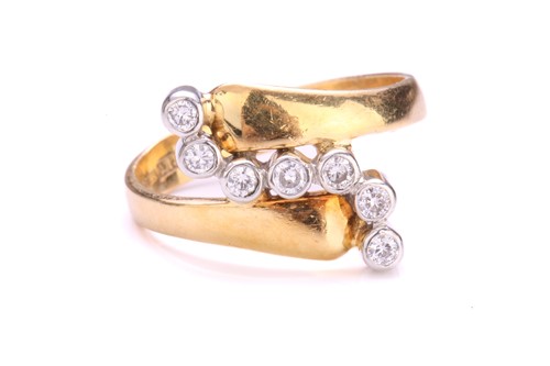 Lot 242 - A diamond bypass ring in 18ct gold, containing...