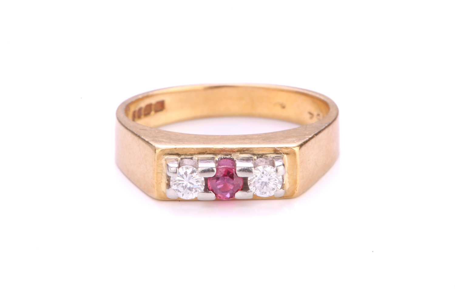 Lot 33 - A three-stone diamond and ruby ring in 18ct...