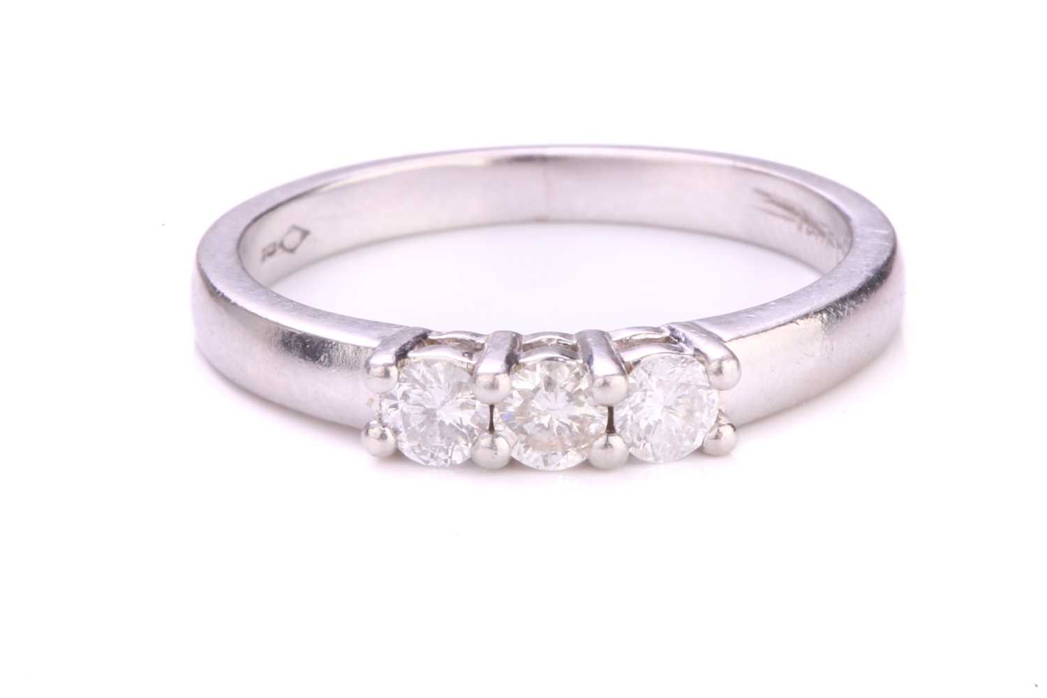 Lot 177 - A three-stone diamond ring in platinum, with...