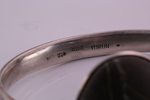 Lot 336 - Torun - 'Arm Ring' with polished rock, a...