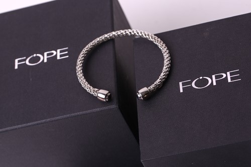 Lot 29 - FOPE - A Silver Fope bangle with sapphires...