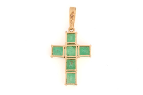 Lot 202 - A cross pendant set with emeralds, comprising...