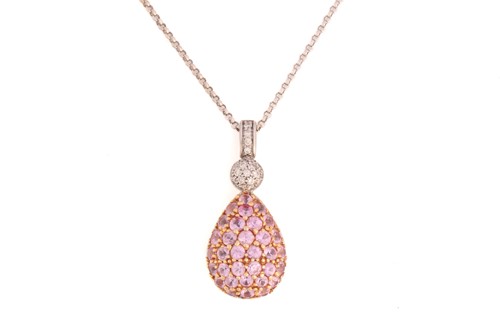 Lot 65 - A pink sapphire and diamond pendant on chain,...