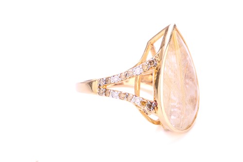 Lot 215 - A rutilated quartz dress ring, featuring...
