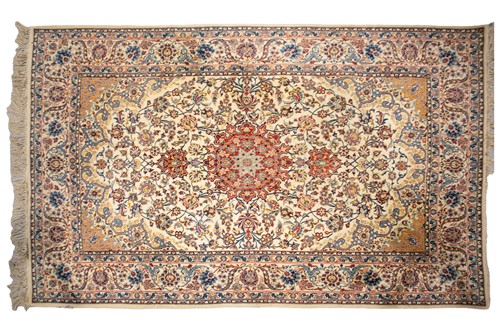Lot 309 - An ivory ground Isfahan rug with central star...