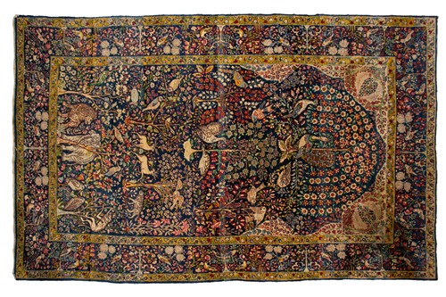 Lot 310 - An old blue ground "Tree of Life " Kerman rug...