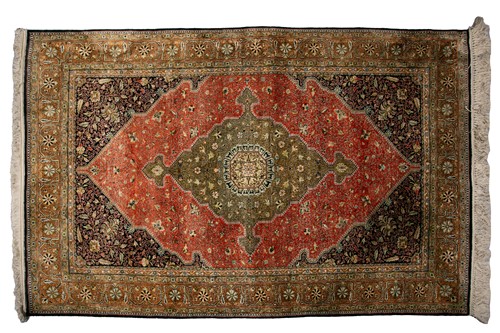 Lot 304 - An old brick red ground silk on silk Tabriz...