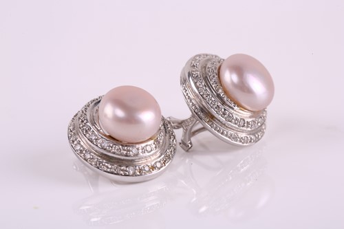 Lot 43 - A pair of pearl and diamond earrings; each...