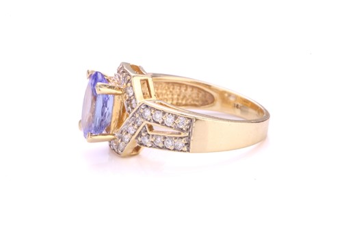 Lot 116 - A tanzanite and diamond dress ring, centrally...