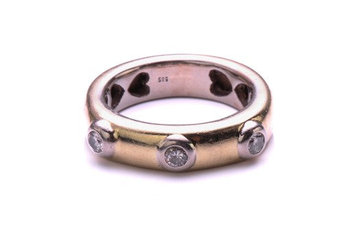 Lot 124 - A three stone half hoop diamond ring; the...