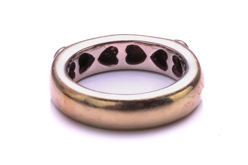 Lot 124 - A three stone half hoop diamond ring; the...