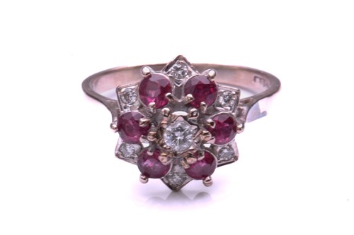 Lot 28 - A ruby and diamond cluster ring, comprising a...