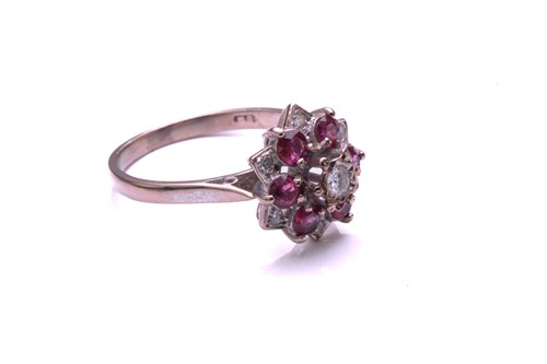 Lot 28 - A ruby and diamond cluster ring, comprising a...