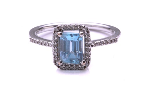 Lot 320 - An aquamarine and diamond cluster ring; the...