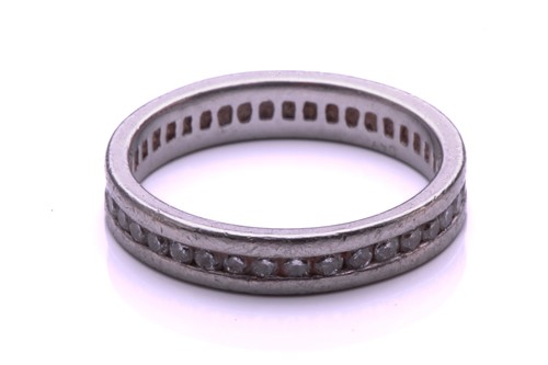 Lot 9 - A full hoop diamond eternity ring, the round...