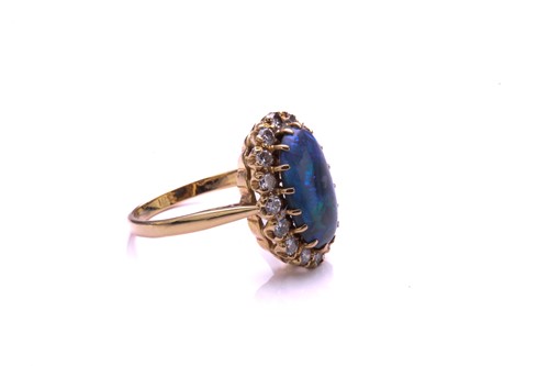 Lot 165 - A black opal and diamond ring, the oval...