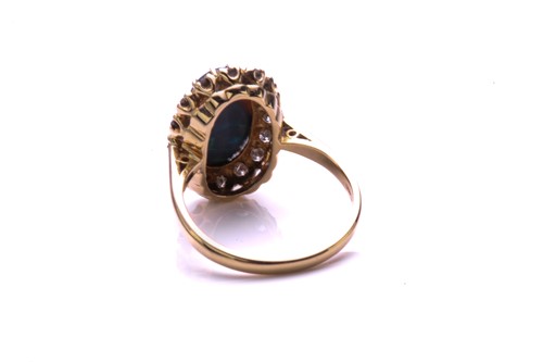 Lot 165 - A black opal and diamond ring, the oval...