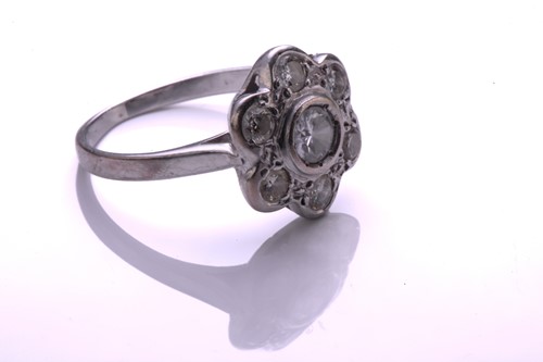 Lot 36 - A diamond cluster ring; the seven stone round...