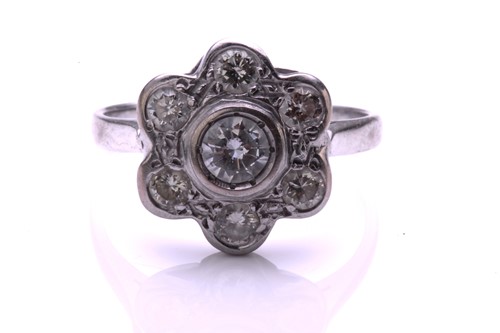 Lot 36 - A diamond cluster ring; the seven stone round...