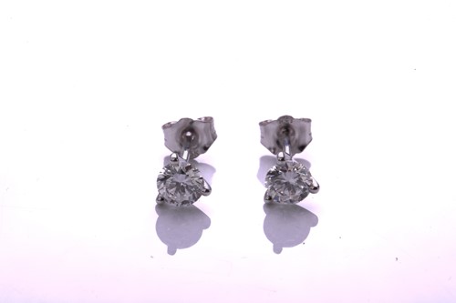 Lot 139 - A pair of diamond earrings, each comprising a...
