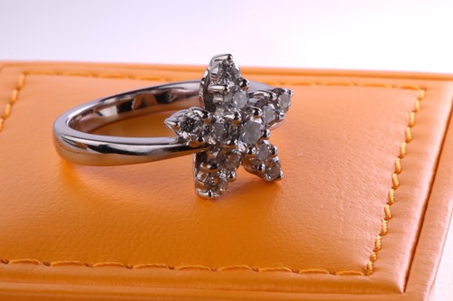 Lot 99 - A French diamond cluster ring, composed of a...