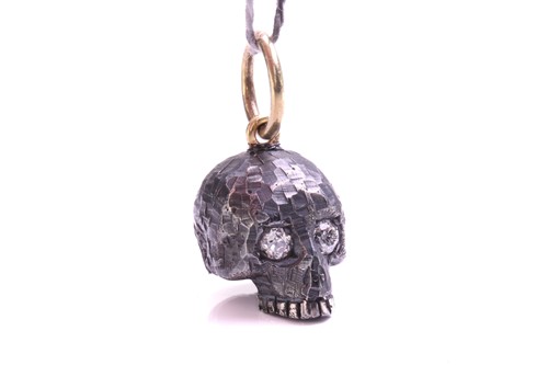 Lot 244 - A skull charm pendant with diamonds, a...
