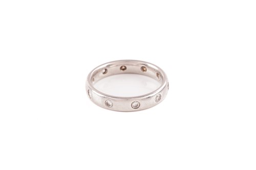 Lot 154 - A diamond-set wedding ring in platinum,...