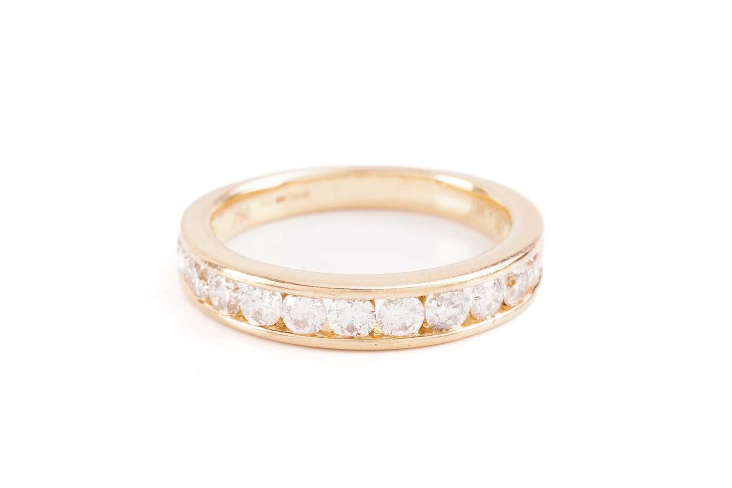 Lot 33 - A diamond half-eternity ring in 18ct yellow...