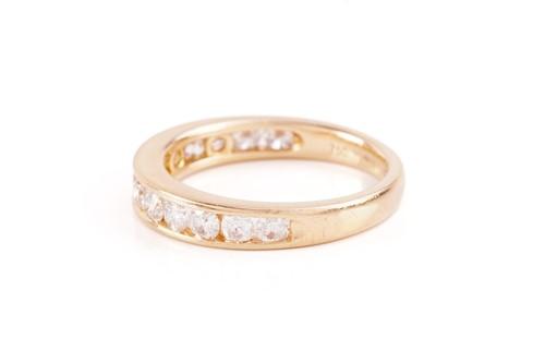 Lot 33 - A diamond half-eternity ring in 18ct yellow...