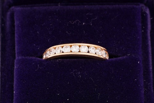 Lot 33 - A diamond half-eternity ring in 18ct yellow...