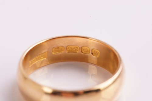 Lot 22 - A plain 22 carat gold wedding band; plain...