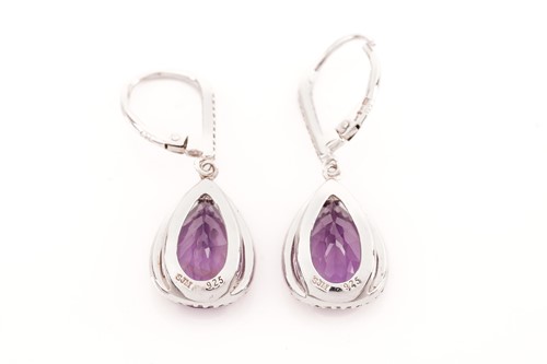 Lot 15 - A pair of amethyst and cubic zirconia pendant...