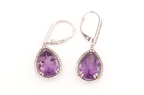 Lot 15 - A pair of amethyst and cubic zirconia pendant...
